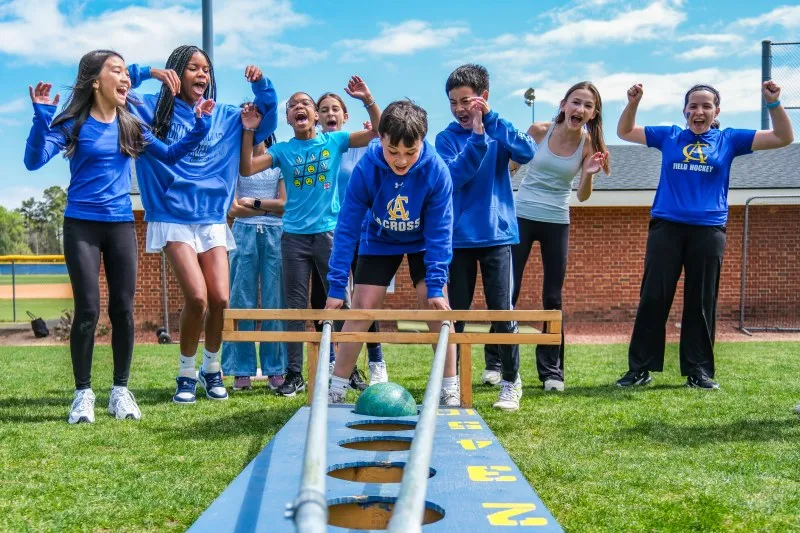 Middle School students cheer during a field day game