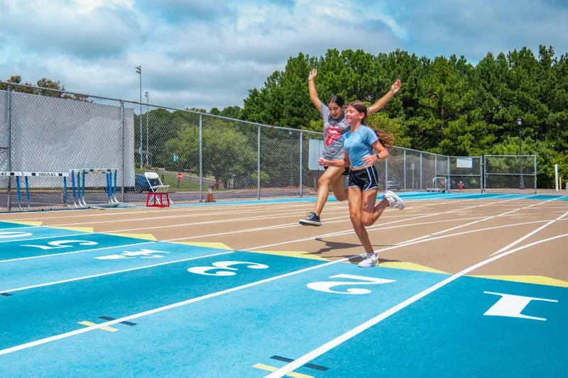 A runner crosses the finish line on the track